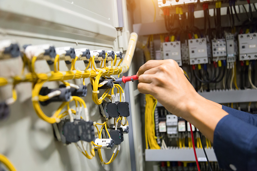 electricians-hands-testing-current-electric-control-panel